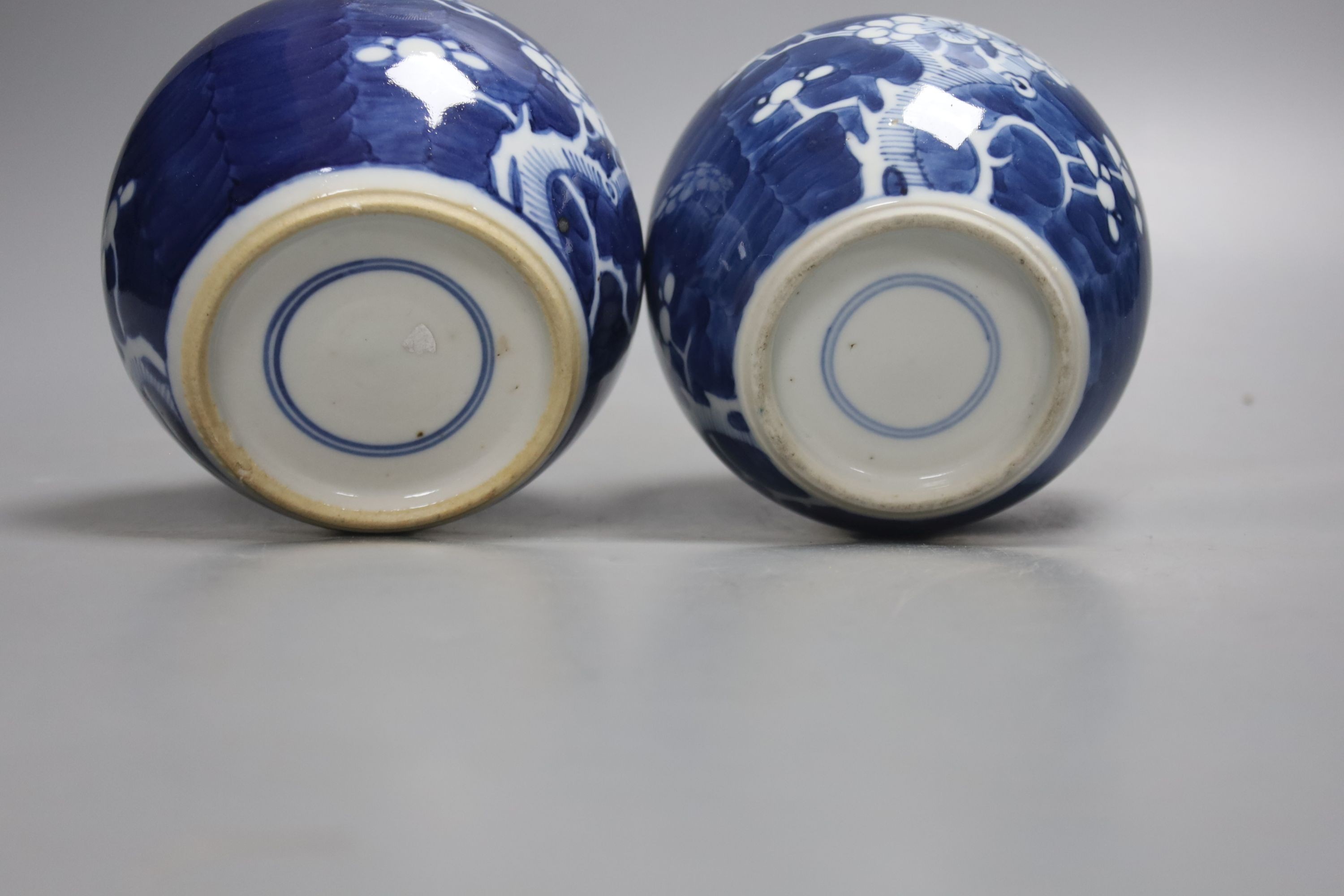 A pair of early 20th century blue and white prunus jars and covers